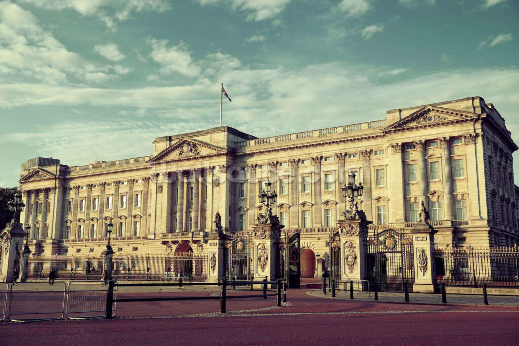 Buckingham Palace vintage wallpaper showcasing grand neoclassical architecture under dramatic sky