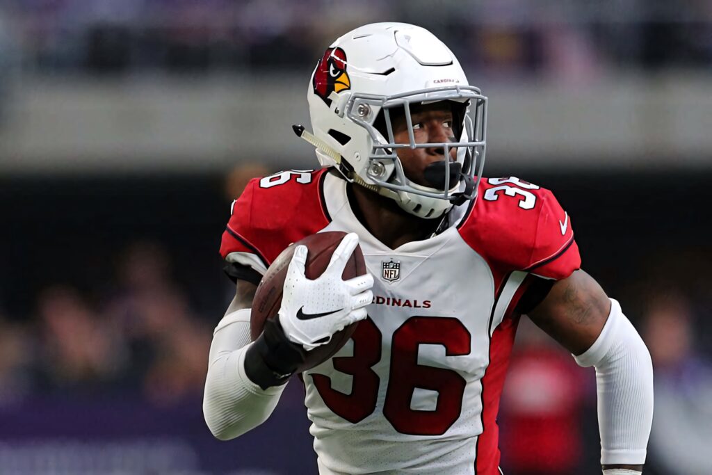 Arizona Cardinals Budda Baker in action wearing red and white uniform showcasing intensity and athleticism Wallpaper