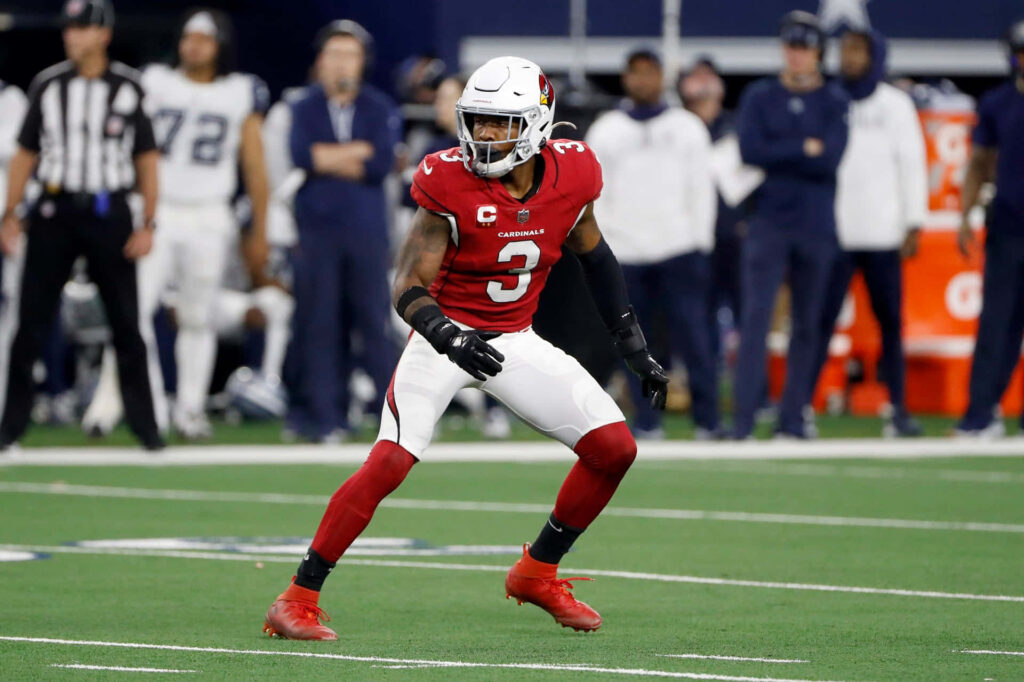 Budda Baker Arizona Cardinals focused defensive stance red white uniform football field game ready Wallpaper