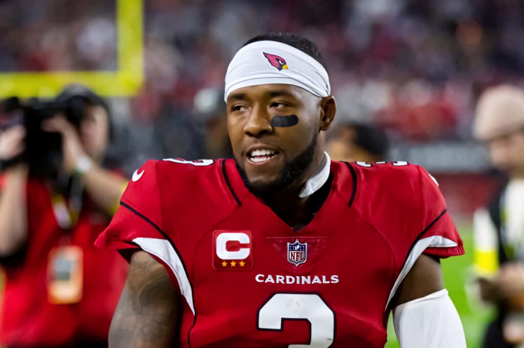 Budda Baker Arizona Cardinals focused on field wearing captain patches and signature headband Wallpaper