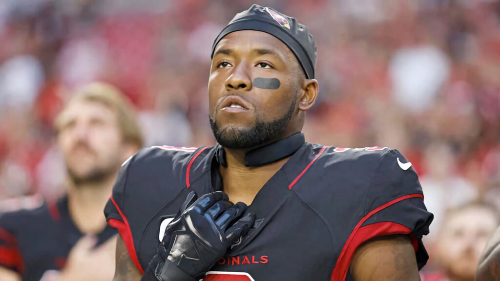 Budda Baker Arizona Cardinals football star in black red uniform with stadium background wallpaper