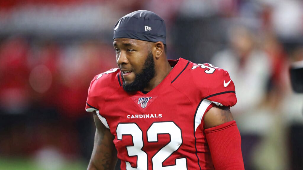 Budda Baker Arizona Cardinals jersey 32 on football field focused athletic NFL player wallpaper