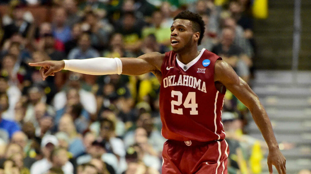 Buddy Hield in Oklahoma Sooners jersey mid-game showcasing intensity and basketball leadership Wallpaper