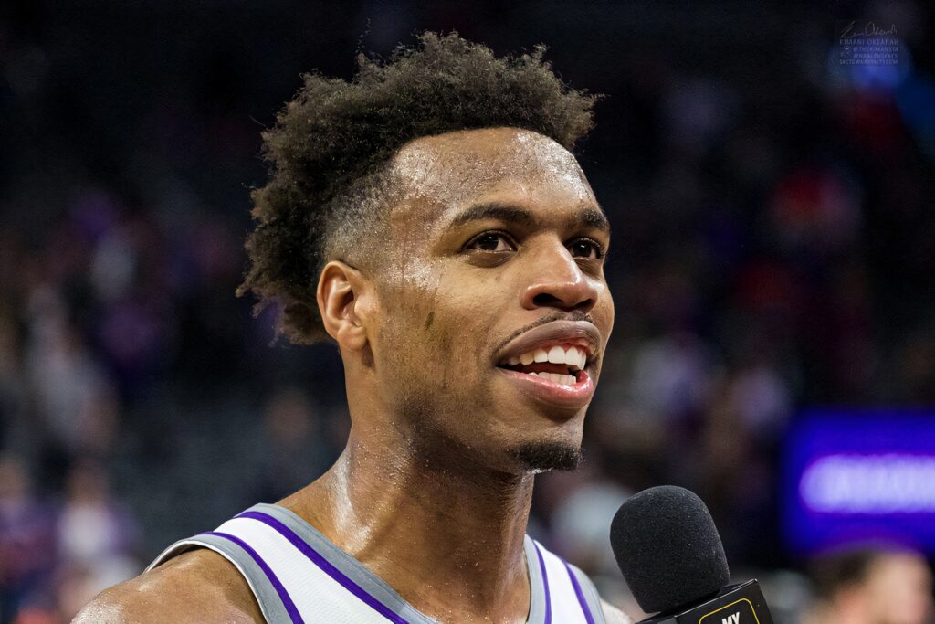 Close-up of Buddy Hield post-game interview vibrant arena background dynamic basketball wallpaper