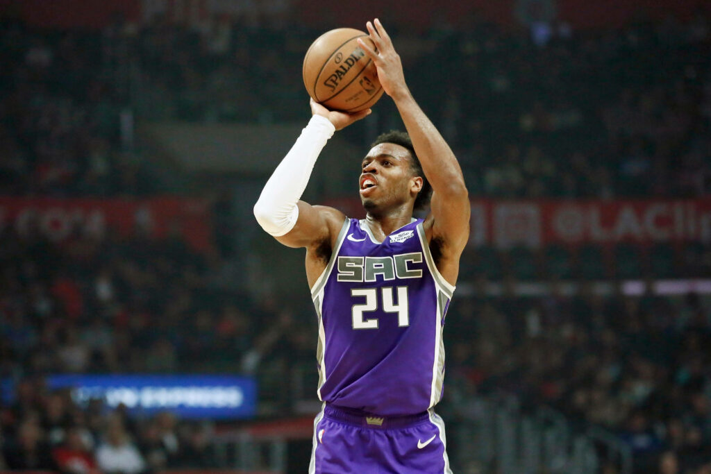 Buddy Hield Sacramento Kings mid-jump shot purple white uniform basketball action wallpaper