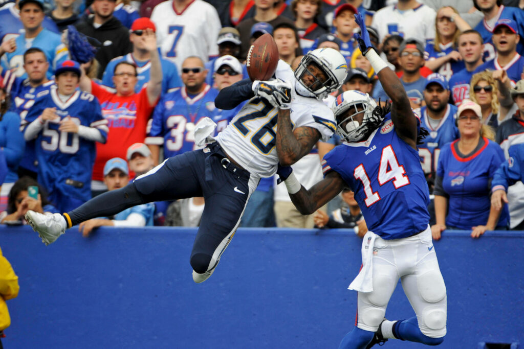 Buffalo Bills player in blue red white uniform hustling on field mid-action NFL game wallpaper