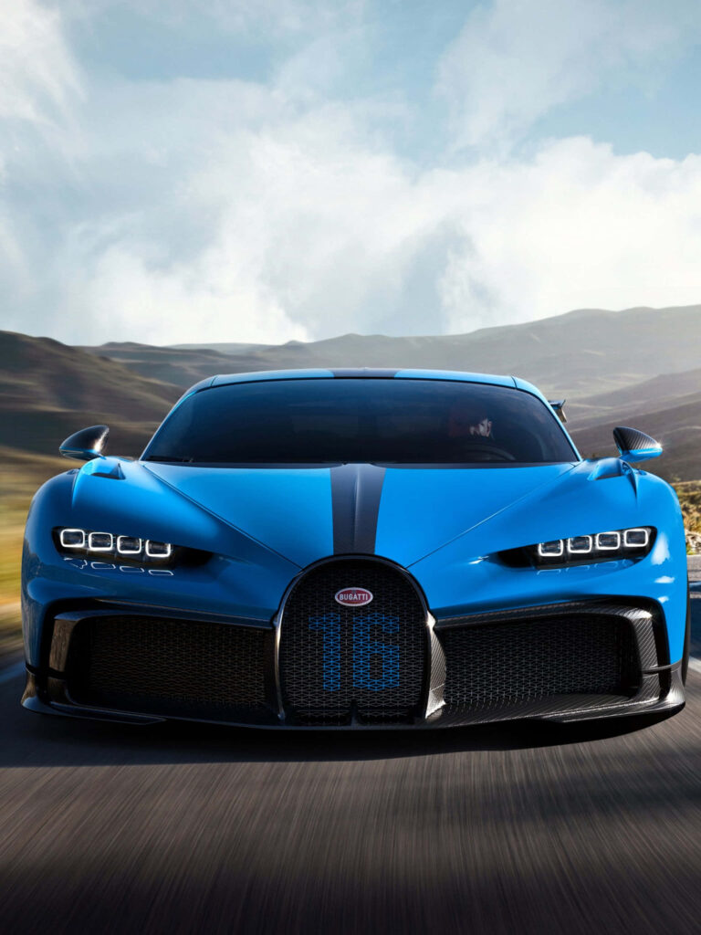 Blue Bugatti supercar speeding on mountain road with aerodynamic design and LED headlights Wallpaper
