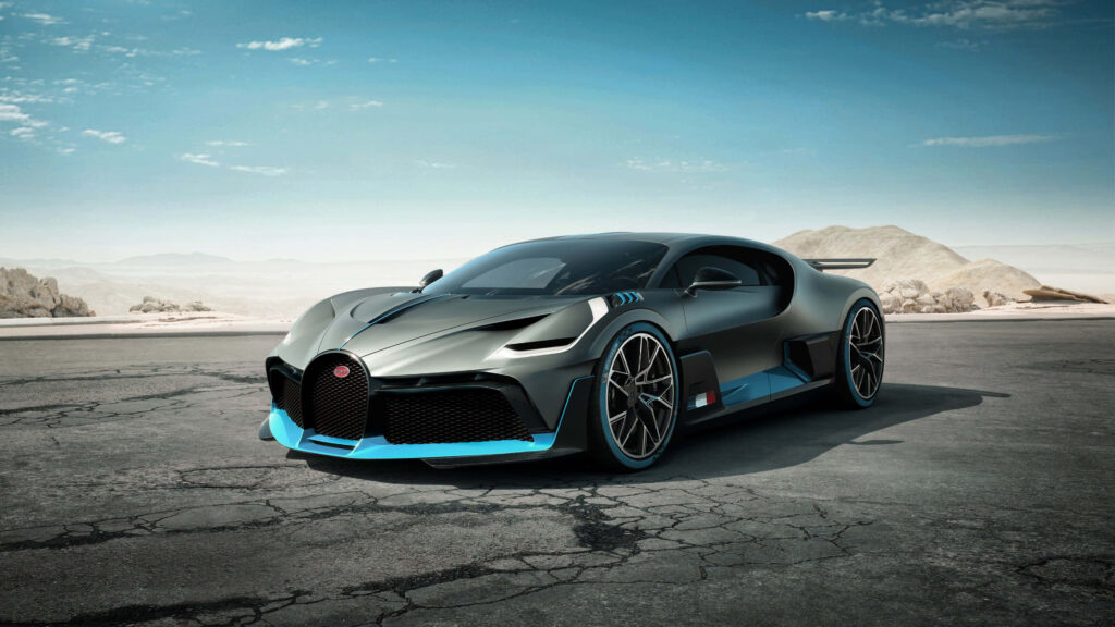 Bugatti Chiron concept car in desert landscape with sleek futuristic design under blue sky Wallpaper