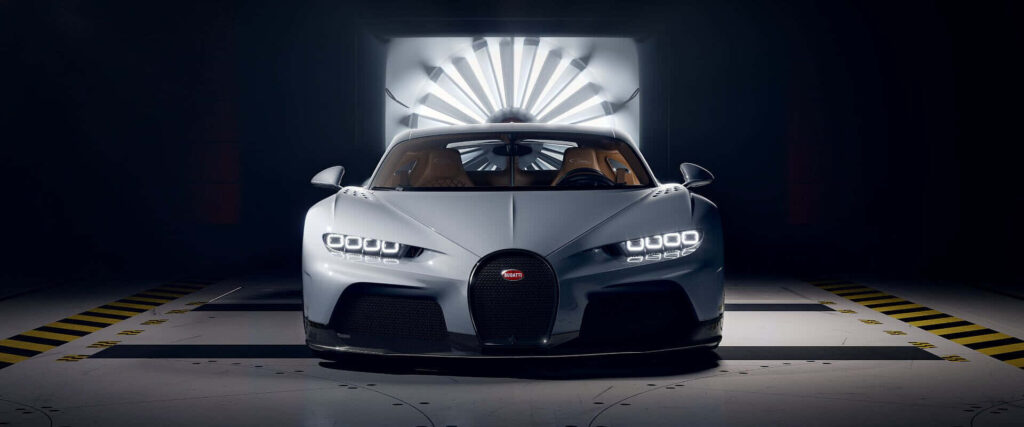 Front view of Bugatti Chiron in dim garage showcasing sleek luxury sports car design wallpaper