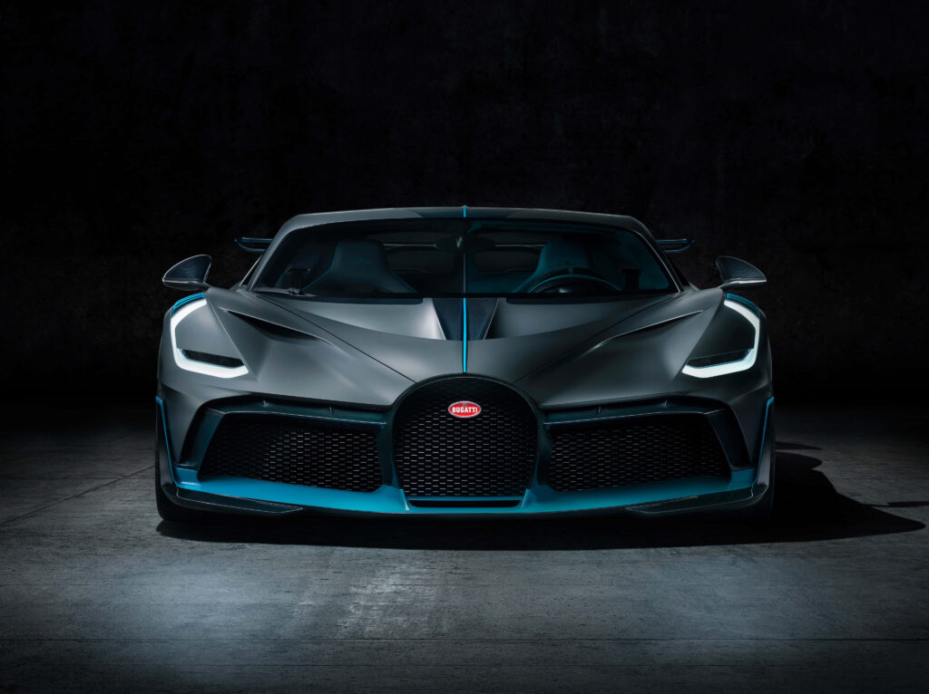 Front view of Bugatti with sharp lines aggressive design and iconic grille in dramatic light Wallpaper