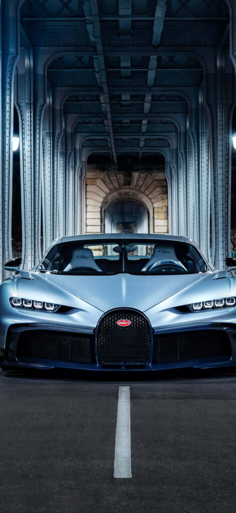 Sleek metallic blue Bugatti parked under steel bridge with urban geometric lines wallpaper background
