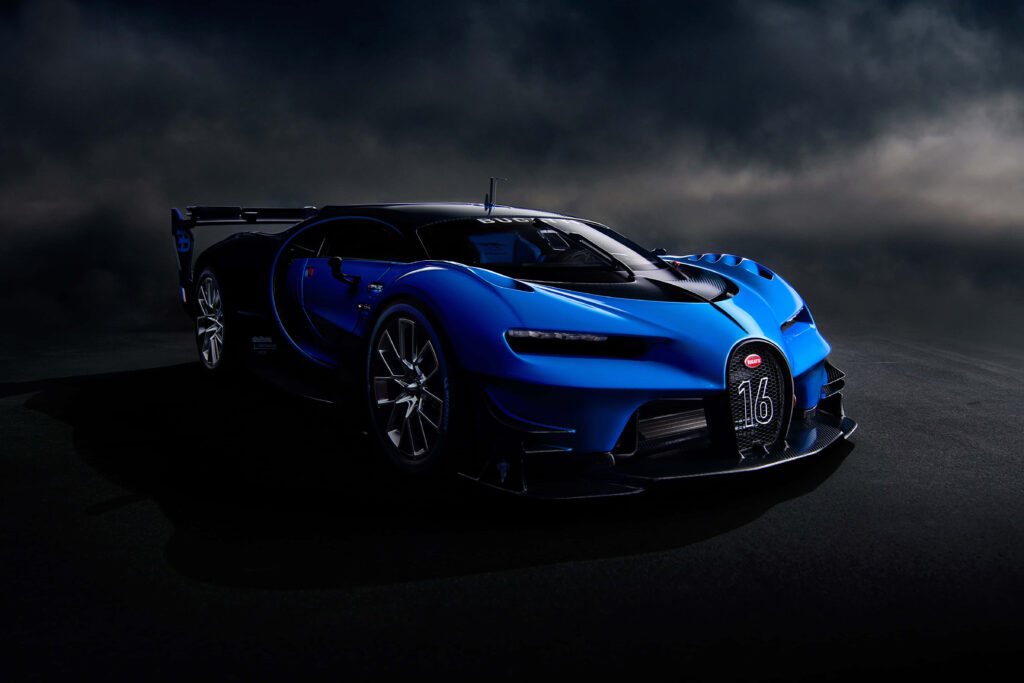 Bugatti sports car in dark setting with vivid blue highlights showcasing luxury and performance Wallpaper