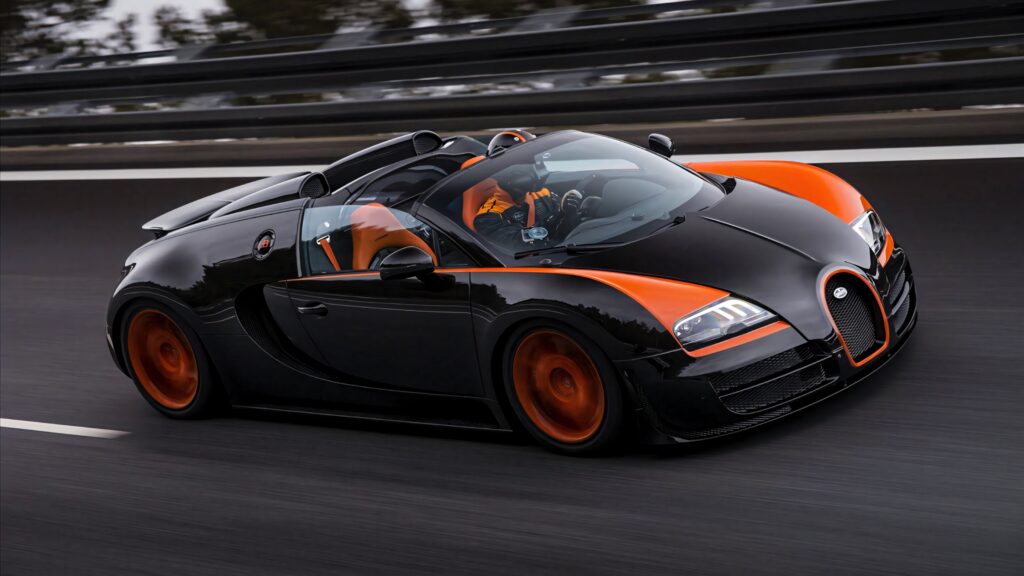 Bugatti Veyron supercar black orange speeding with sleek aerodynamic curves wallpaper background