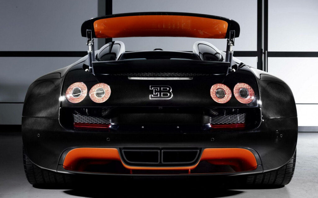 Bugatti Veyron rear view with black carbon fiber and orange accents luxury car wallpaper background