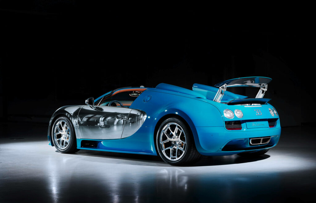 Rear view of blue Bugatti Veyron with open engine cover showcasing luxury and power design Wallpaper