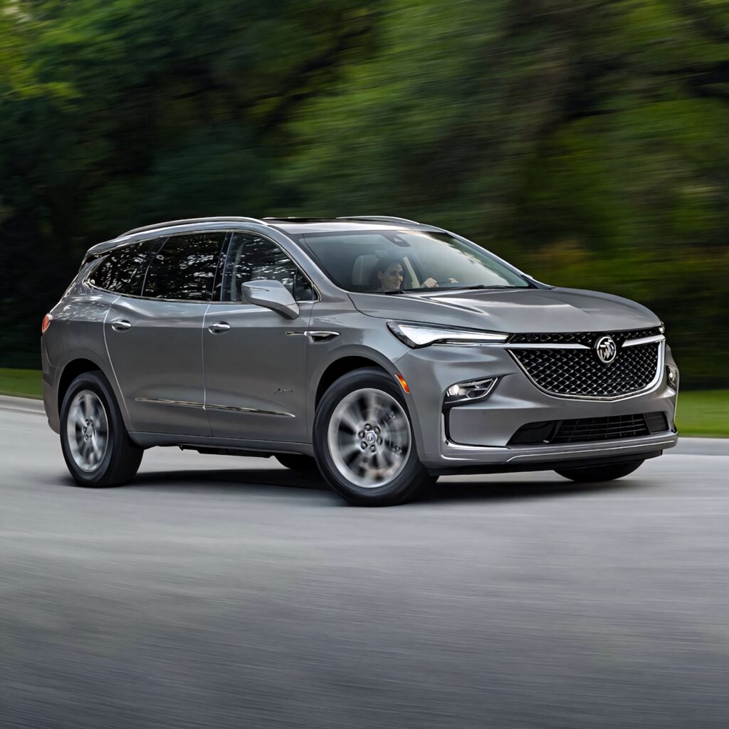 Buick Enclave driving on winding road showcasing modern design and dynamic performance outdoors Wallpaper