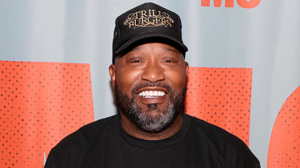 Bun B smiling rapper with black cap Trill Burgers gold text black shirt vibrant style wallpaper
