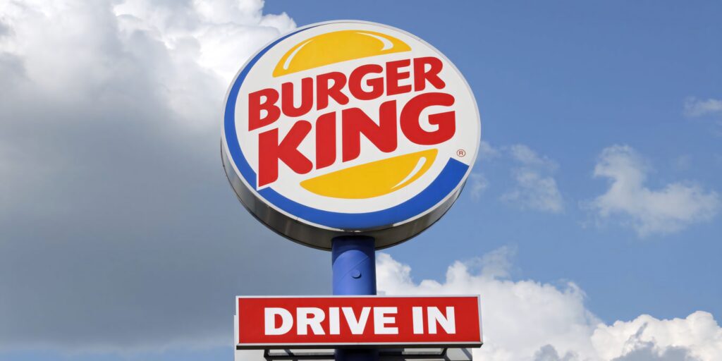 Bold Burger King sign with vibrant sky and clear Drive In message fast food wallpaper background