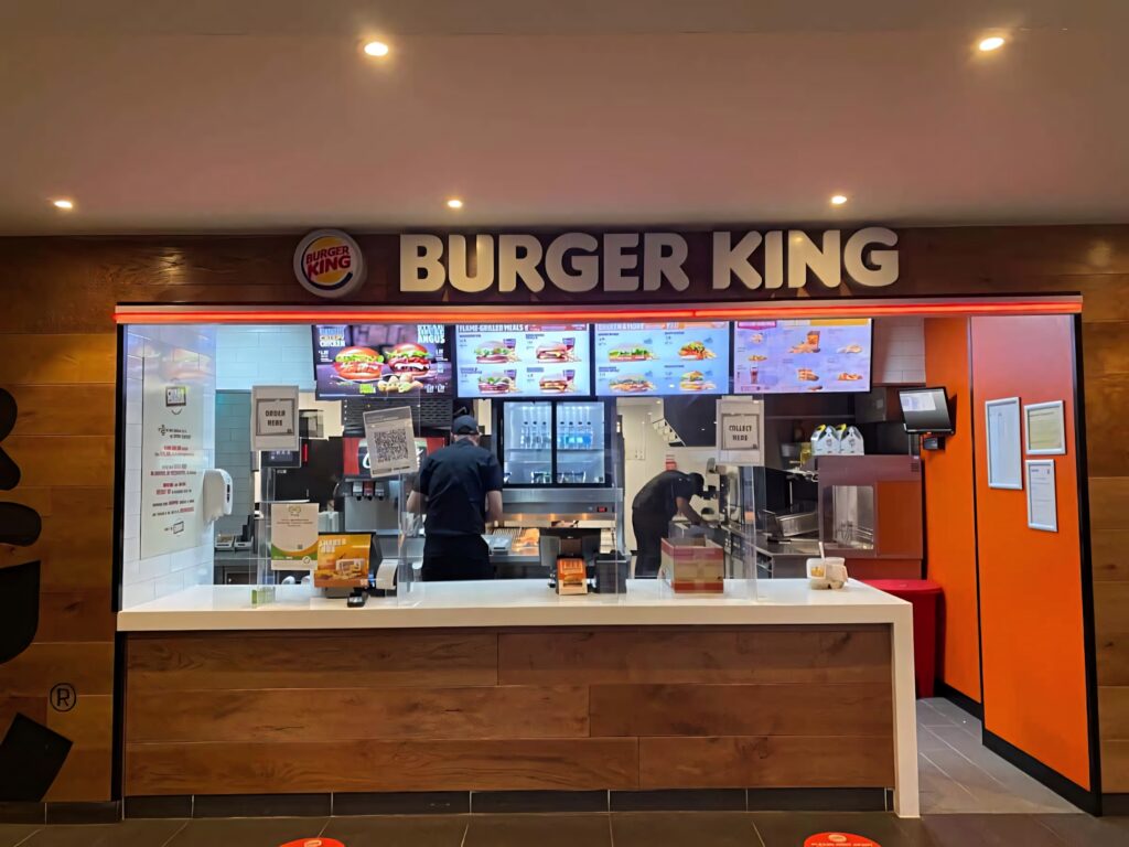 Burger King Sydney modern counter with digital menus staff preparing meals vibrant fast-food interior Wallpaper