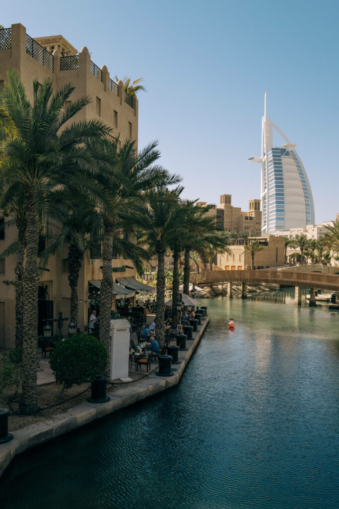 Burj Al Arab hotel over turquoise waters with palm trees under clear blue sky Jumeirah wallpaper