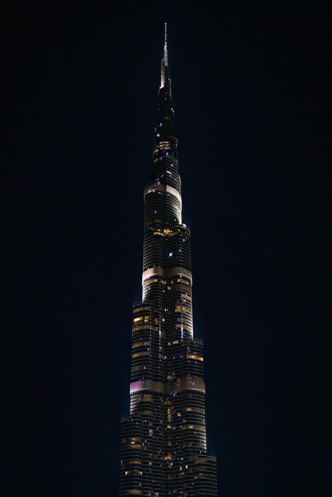 Burj Khalifa at night illuminated with glinting lights showcasing sleek modern architecture Wallpaper