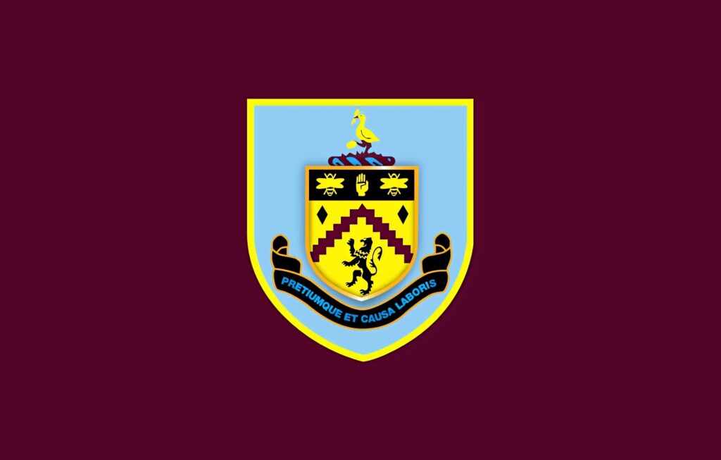 Burnley FC wallpaper with iconic crest on deep claret background showcasing football heritage
