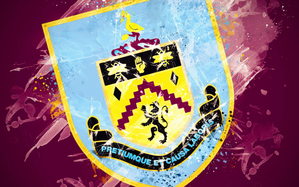 Burnley FC wallpaper with iconic crest on vibrant maroon and blue paint splash background