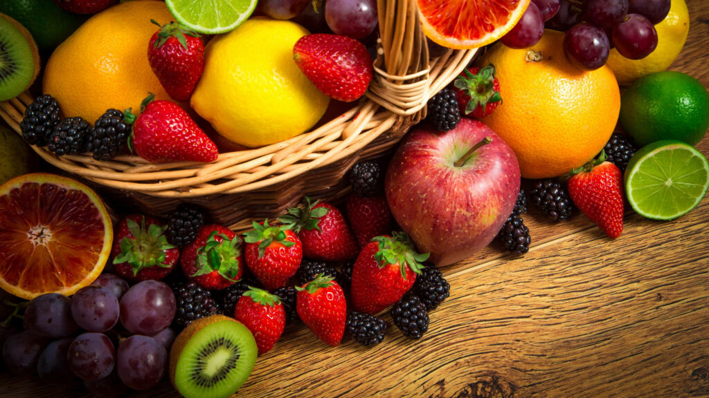 Bursting with Color: A Macro Shot of Assorted Fruits on a Wooden Table - 4k Wallpaper to Brighten Your Screen