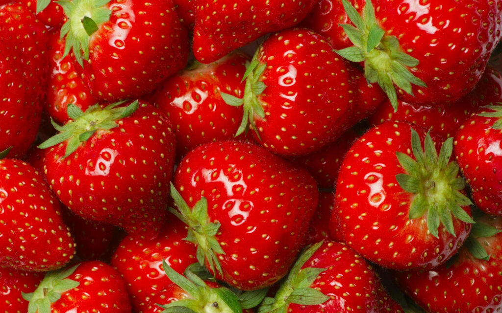 Top-Down Delight: Shiny Strawberry Fruits in a Breathtaking Desktop Wallpaper
