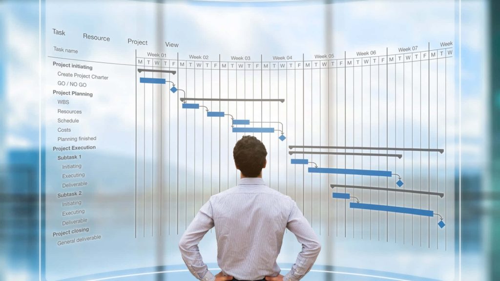 Businessman viewing glowing blue holographic Gantt chart digital wallpaper for project management