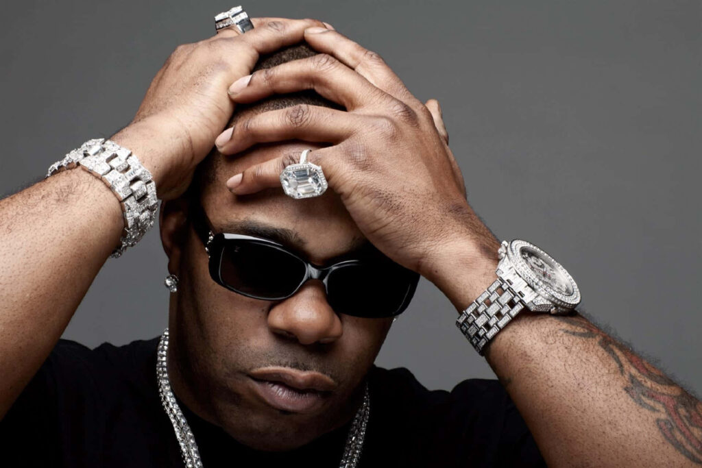 Busta Rhymes close-up with diamond jewelry large rings dark sunglasses gray background wallpaper