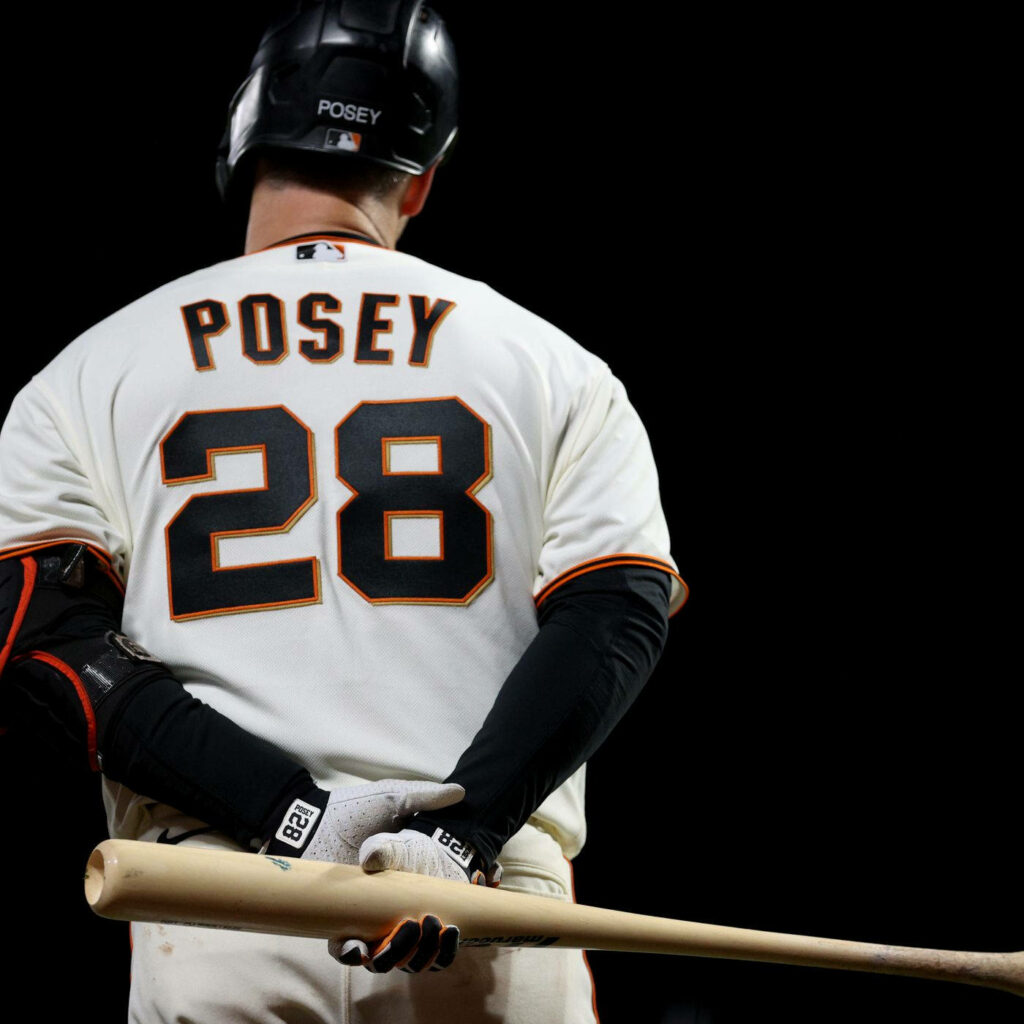 Buster Posey back view in Giants uniform number 28 holding bat dark dramatic background wallpaper