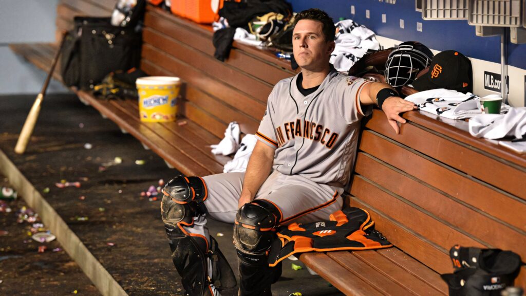 Buster Posey Giants catcher in gear sitting thoughtful on dugout bench with baseball equipment Wallpaper