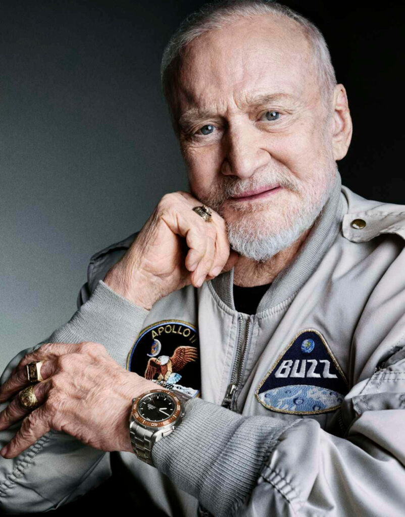 Buzz Aldrin Apollo 11 astronaut in flight jacket with mission patches historic space exploration wallpaper