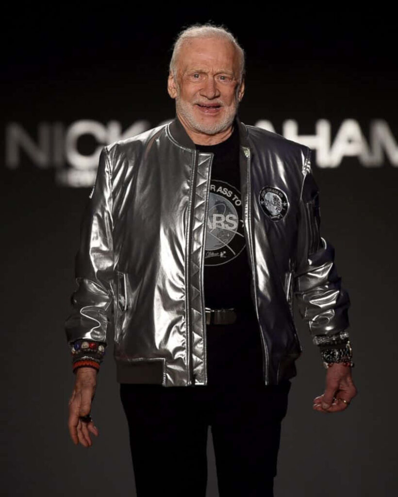 Buzz Aldrin in silver jacket astronaut wallpaper dark minimalist space exploration background