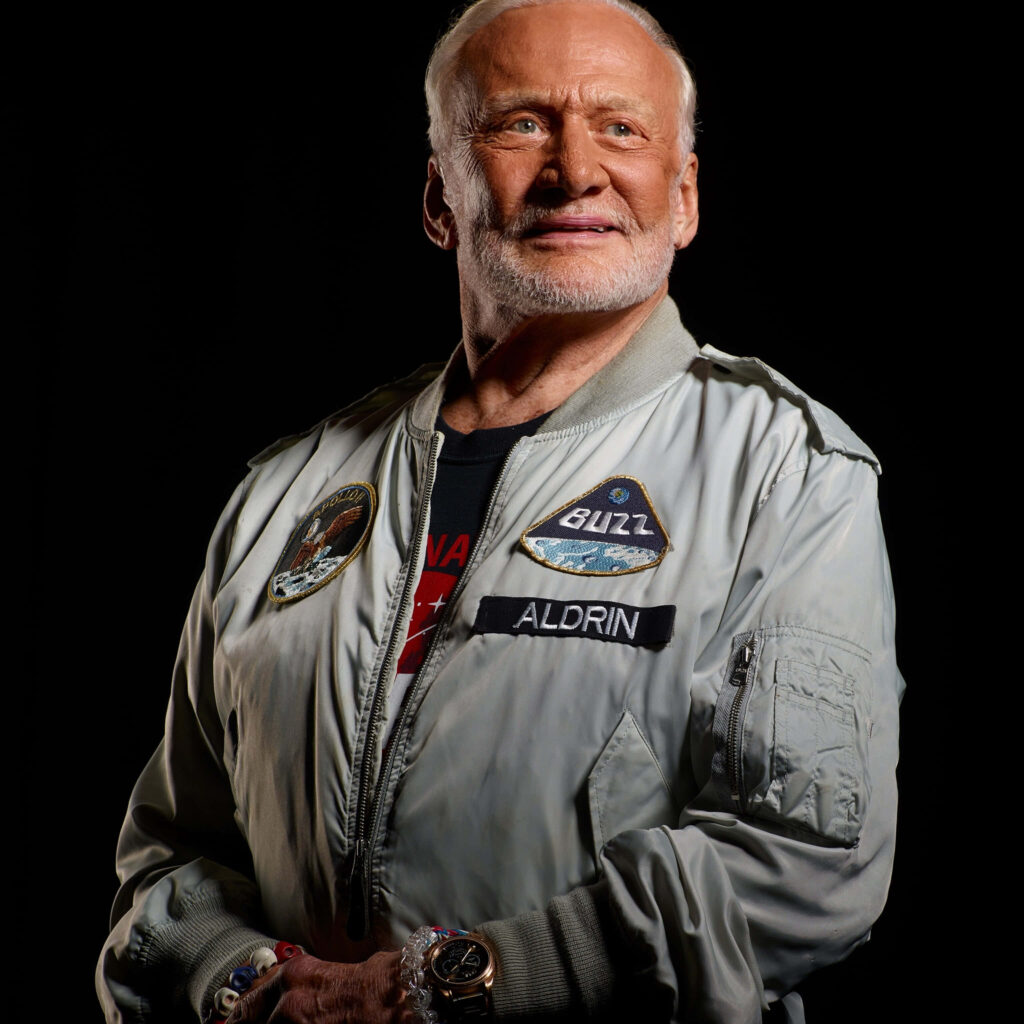 Buzz Aldrin wearing flight jacket with mission patches portrait space exploration wallpaper background