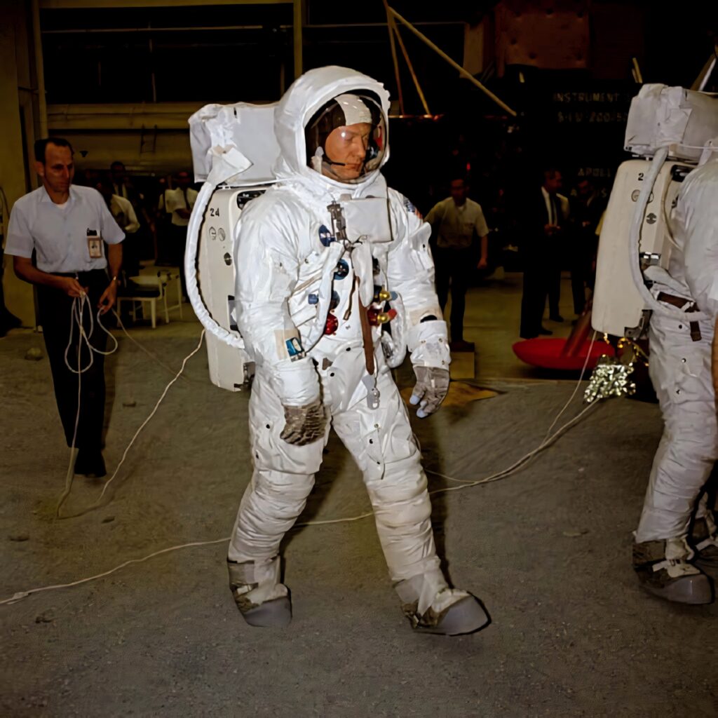 Buzz Aldrin in Apollo astronaut suit during NASA lunar mission testing with engineers nearby Wallpaper