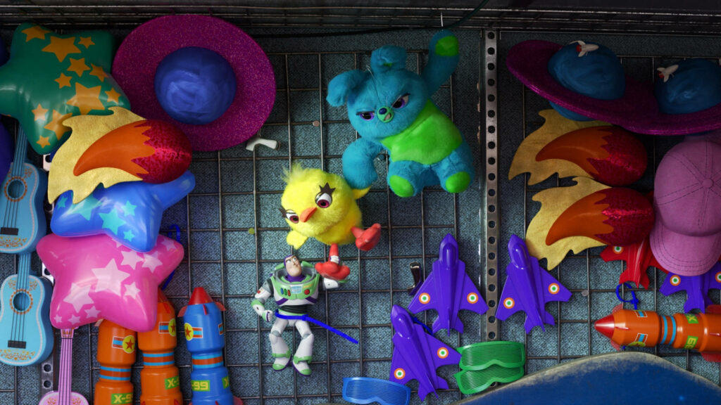 Buzz Lightyear hanging on wire grid with colorful carnival prizes plush toys hats rocket ships Wallpaper