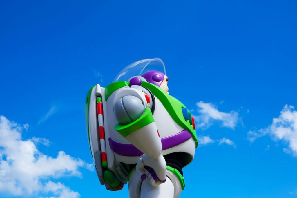 Buzz Lightyear in detailed space suit against bright blue sky ultra wide 4K wallpaper background