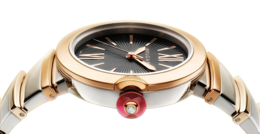 Elegant Bvlgari watch side view with rose gold accents two-tone bracelet and black dial Wallpaper