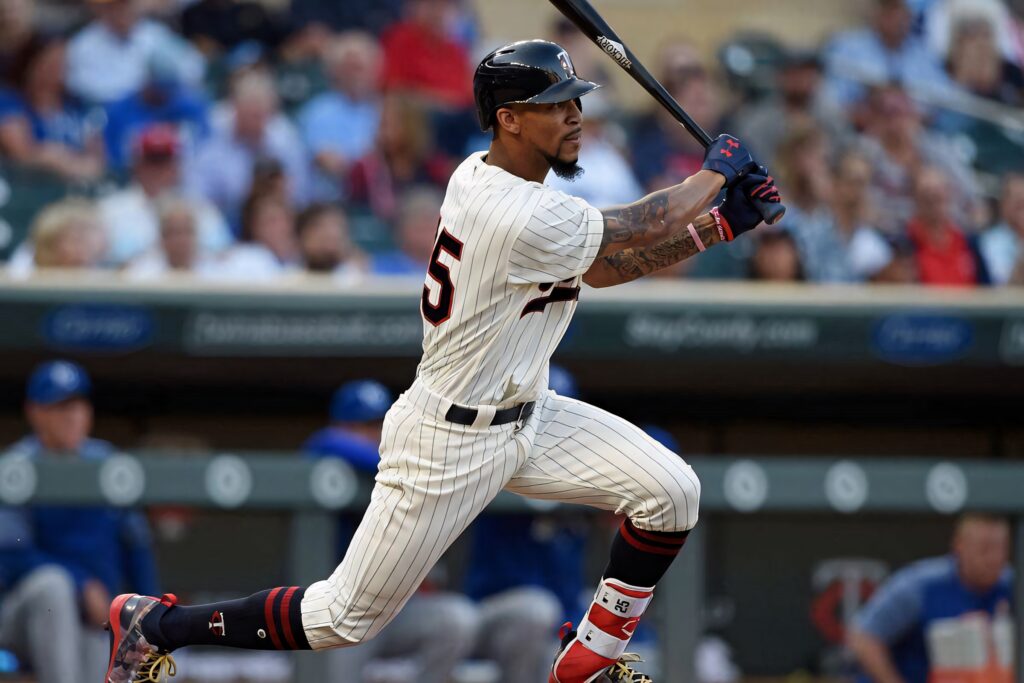 Byron Buxton batting in white pinstripe uniform showing athletic form and focus on field Wallpaper