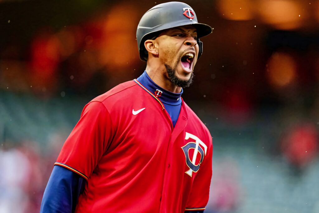 Byron Buxton shouting in red Minnesota Twins uniform during intense rainy baseball game wallpaper