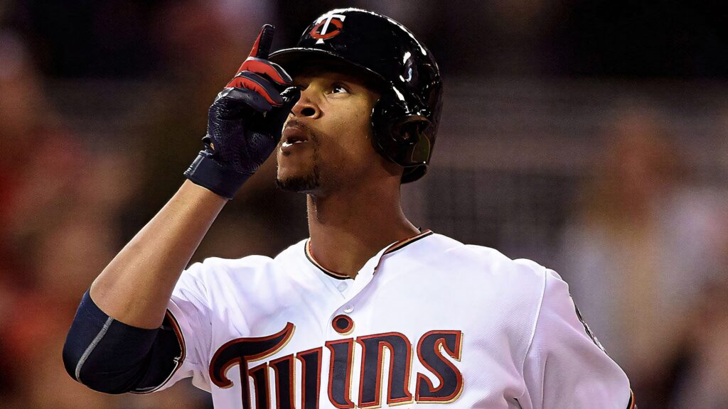 Byron Buxton Minnesota Twins celebrating pointing upward in white jersey black helmet on field Wallpaper
