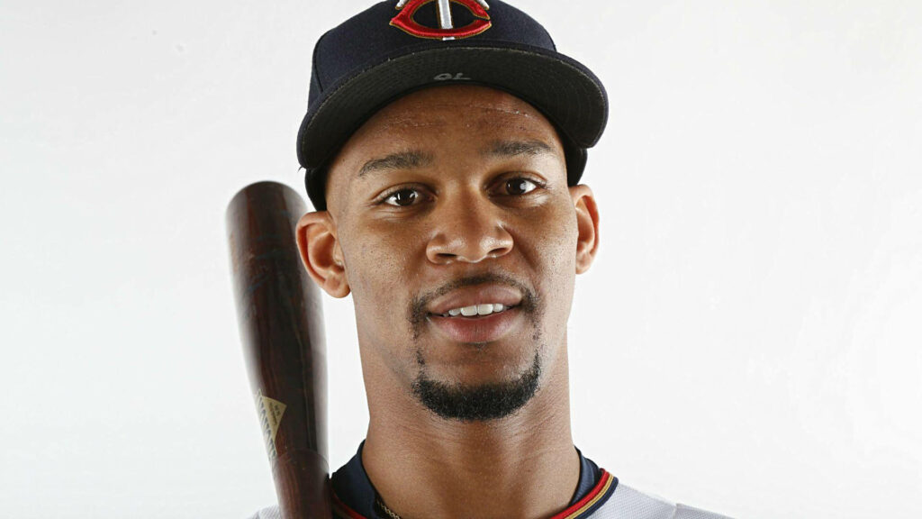 Byron Buxton close-up in Minnesota Twins uniform holding bat with confident focused expression Wallpaper