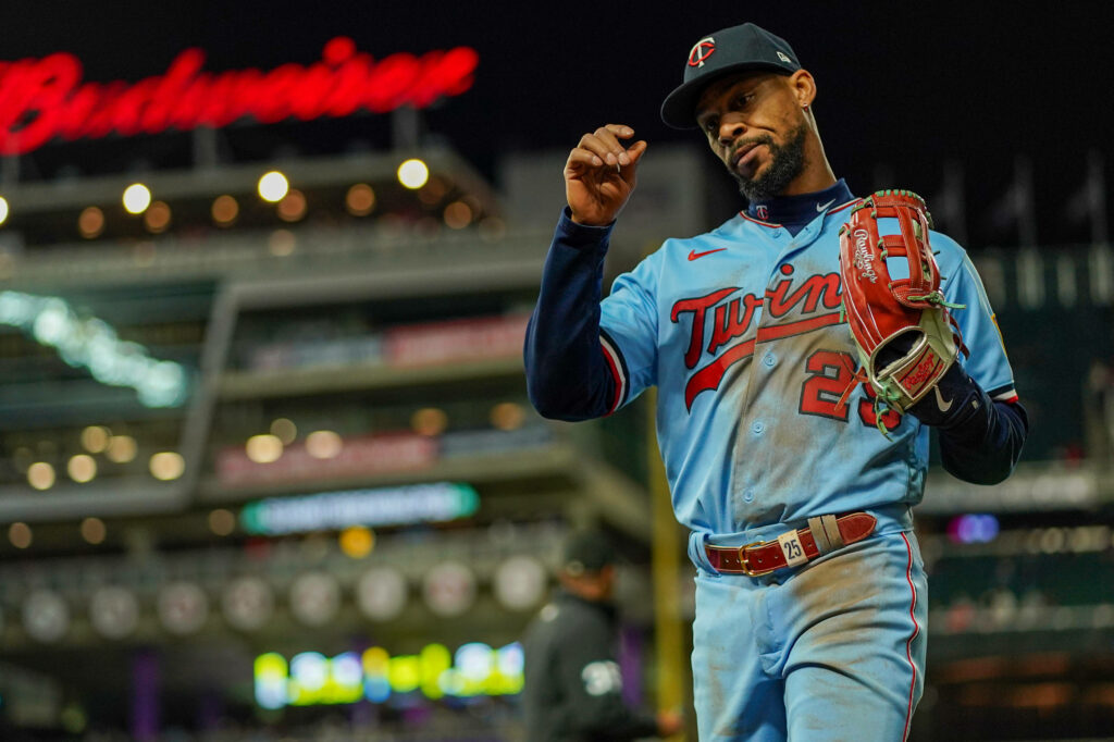 Byron Buxton in light blue Minnesota Twins jersey under stadium lights vibrant baseball wallpaper