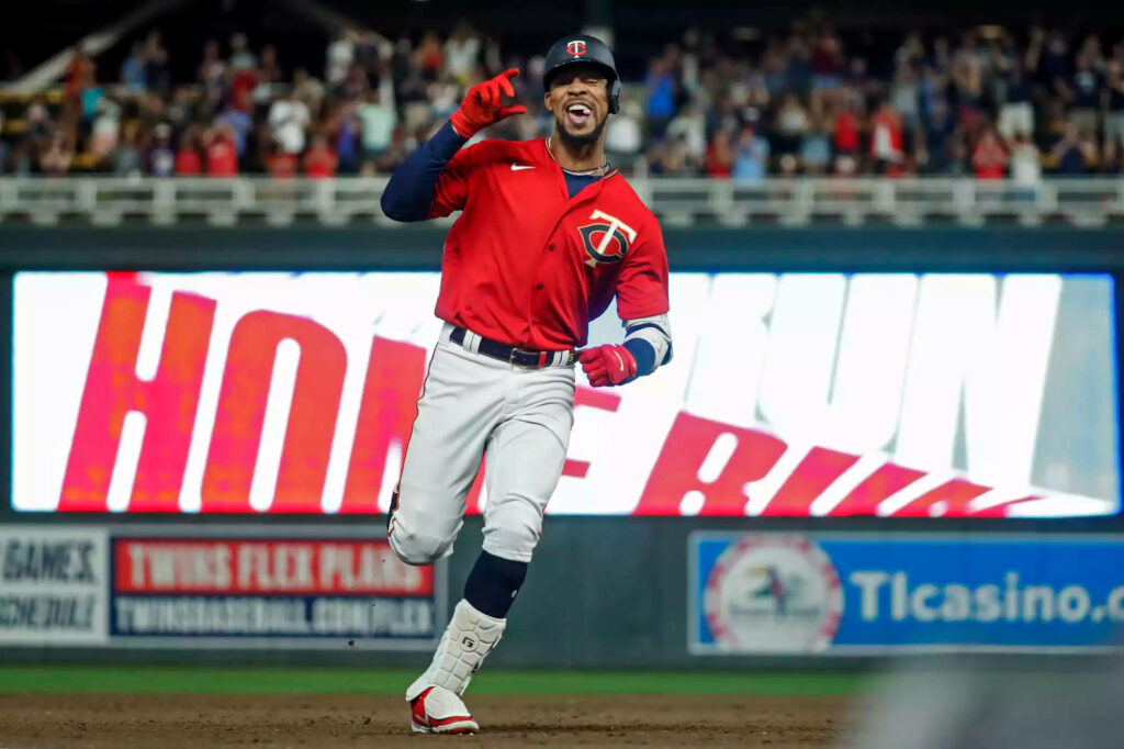 Byron Buxton celebrating home run in Minnesota Twins uniform with stadium lights and crowd Wallpaper