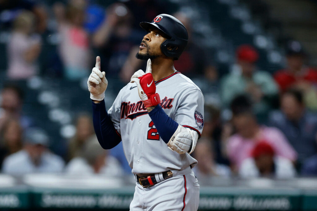 Byron Buxton Minnesota Twins pointing upward on baseball field celebrating dynamic sports moment Wallpaper