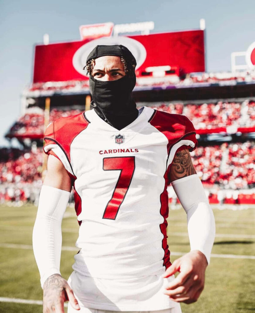Byron Murphy in Arizona Cardinals red and white uniform on field bright daylight game day action Wallpaper