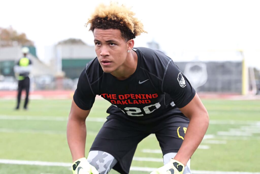 Byron Murphy focused in football gear and gloves on green field showing athletic determination Wallpaper