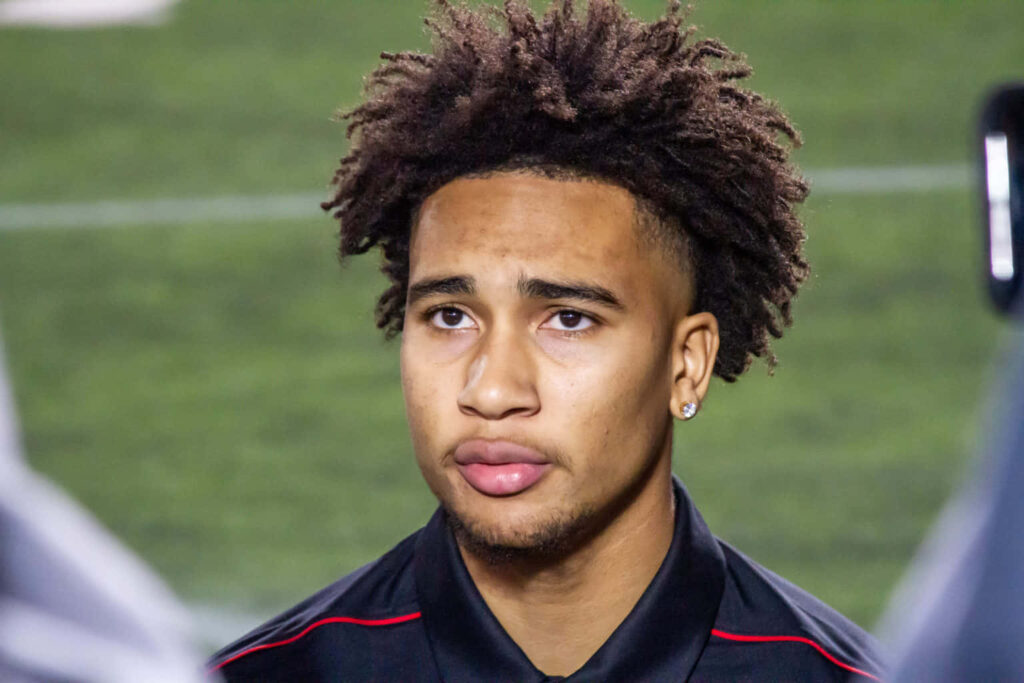C J Stroud focused portrait with signature hairstyle blurred background football wallpaper